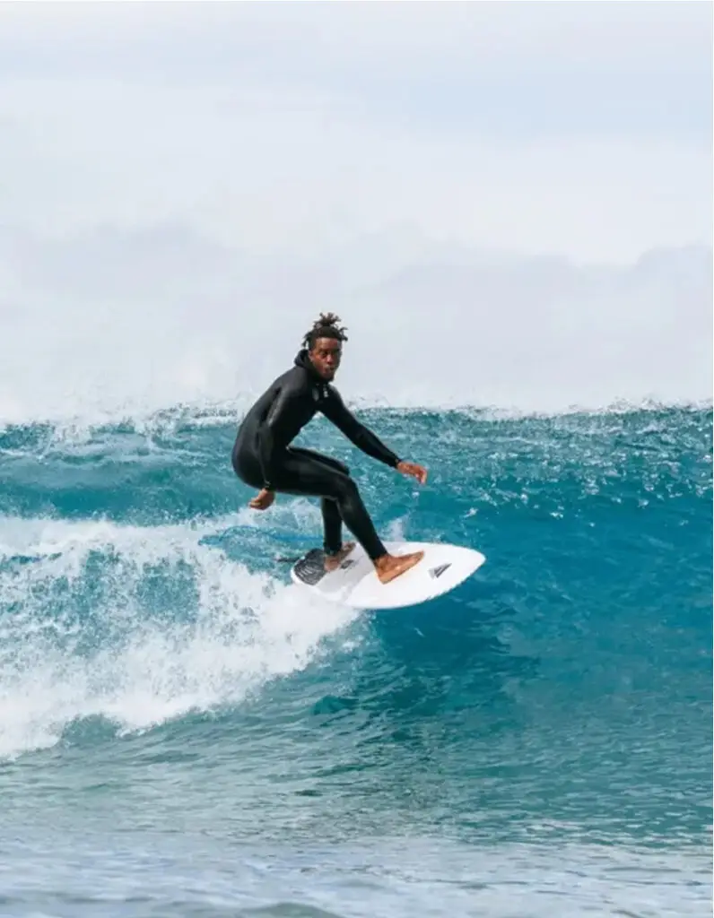 Surfer riding a wave at the beach during the Recharge Conference in San Diego.